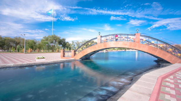 Bridge and pond in Park named after the First President of the Republic of Kazakhstan in the city of Aktobe . Western Kazakhstan.