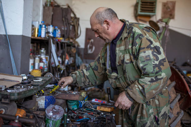 istock Hardworking Tractor Mechanic in His Repair Garage 1293289175