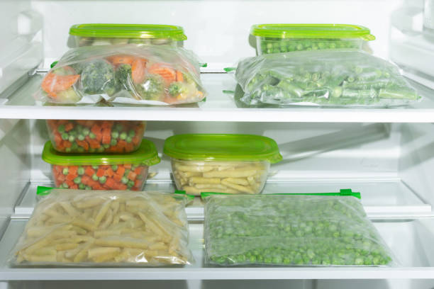 istock Plastic containers and bags with different frozen vegetables in refrigerator. 1293289292