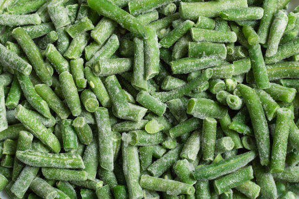 istock Green frozen string beans background top view. 1293289348