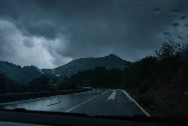 Bad weather conditions with heavy rain and some snow on a road through Sierra de Tramuntana on balearic island Mallorca. Spain, November 2014
