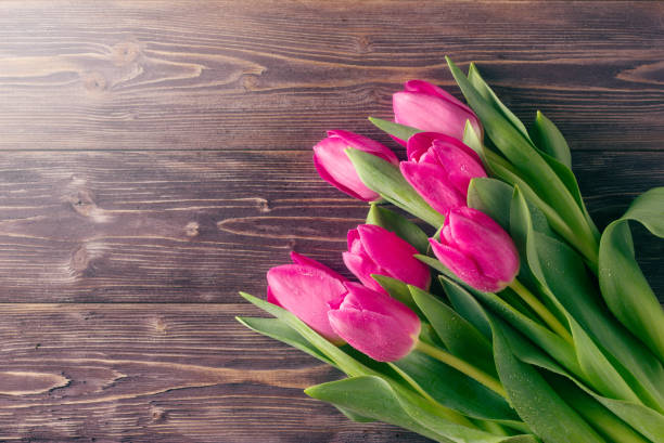 istock Pink tulips on a wooden background. Top view. 1293291349