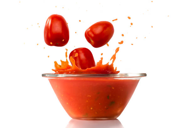 istock tomatoes fall into glass bowl with splashing tomato sauce 1293292163