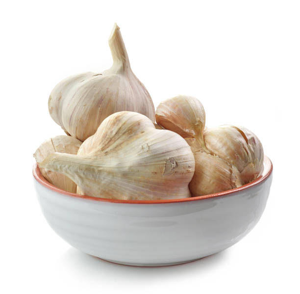 istock bowl of garlic isolated on white background 1293292440