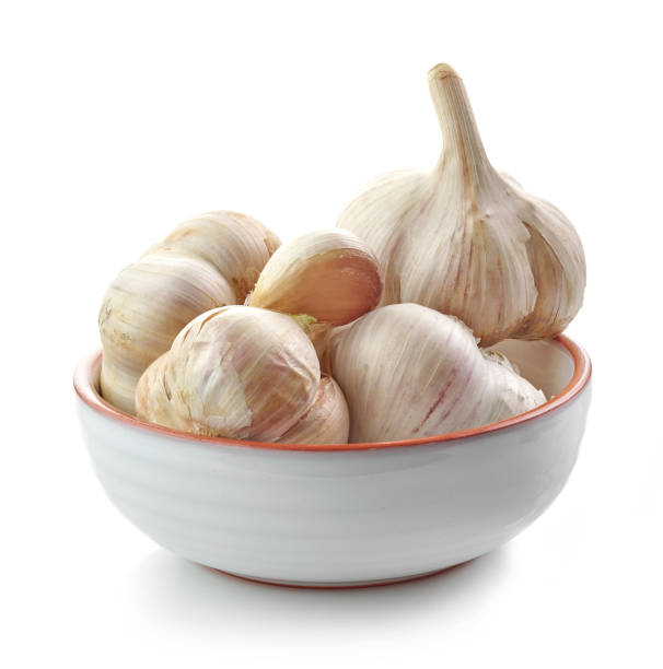 istock bowl of garlic isolated on white background 1293292443