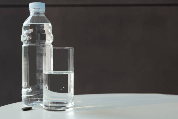 istock Bottle and a glass of water on the table. 1293292580