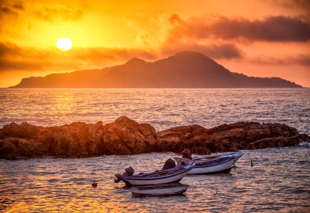 Sunset in Galicia with Cies Islands Sunset in Galicia with some boats and Cies Islands in the background from Praia de Portiño beach, Vigo, Rias Baixas, Pontevedra vigo stock pictures, royalty-free photos & images