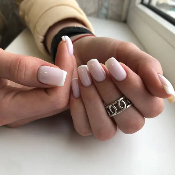 Photo of French manicure on the nails. French manicure design. Manicure gel nail polish