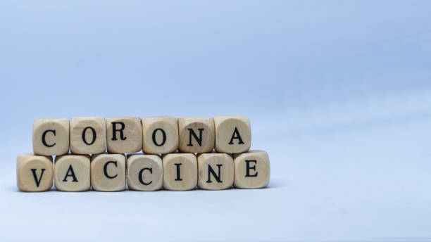 istock Lettering Corona Vaccine on wooden cubes 1293293526