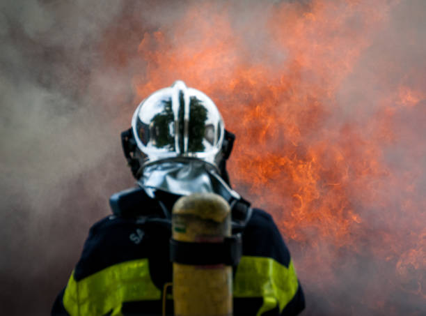 istock French Fireman standing in front of a flaming background. 1293294572