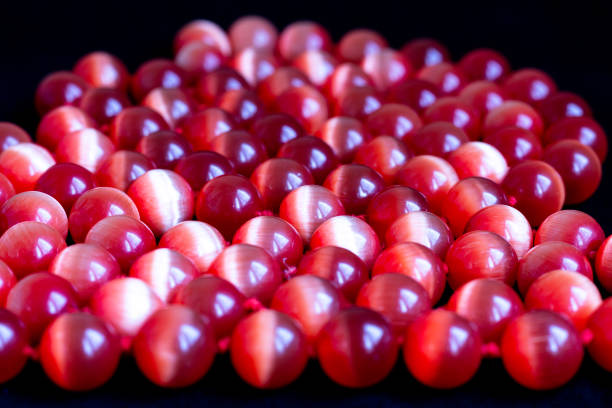 A red beaded necklace made from a cat's eye gem (chrysoberyl).