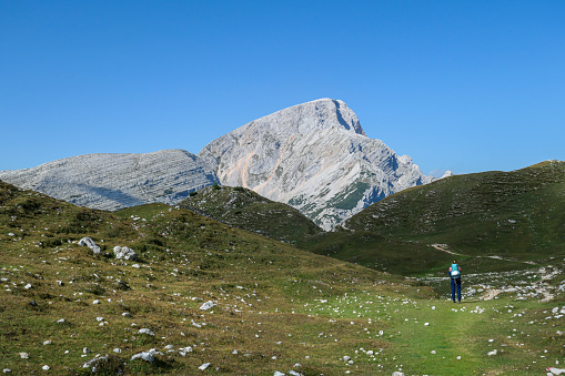 Monte Rosa, Italy - 1 September 2023 - A mountains view in Valle d'Ayas with Monte Rosa mount peak of Alps, alpinistic paths to Rifugio Mezzalama e Guide di Ayas, with Blu lake; Valle d'Aosta region. Here in particular a girl alpinist in Rifugio Mezzalama refuge.