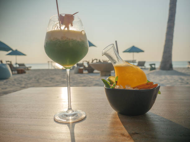 istock Two tropical cocktails on beach at sunset 1293296387