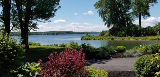 Conesus lake on a bright sunny day View of Conesus lake from Vitale Park in Lakeville, New York. One of the New York Finger lakes. finger lakes stock pictures, royalty-free photos & images