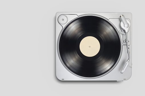 Turntable with long play or LP vinyl record on gray background. Copy space