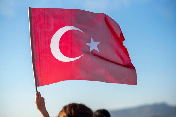 istock unrecognizable people of faces holding Turkish flag in their hands 1293305385