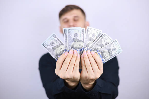 istock businessman man with dollars in his hands 1293306333