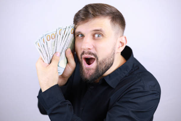 istock businessman man with dollars in his hands 1293306340