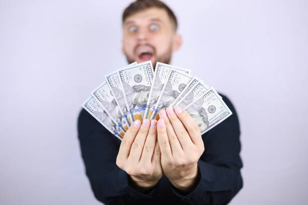 istock businessman man with dollars in his hands 1293306376