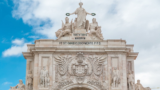 Top of Triumphal arch at Rua Augusta at Commerce square in Lisbon, Portugal. Cloudy sky.