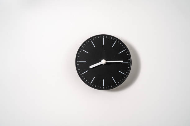 istock close up of an office clock on white background with clipping path 1293308024