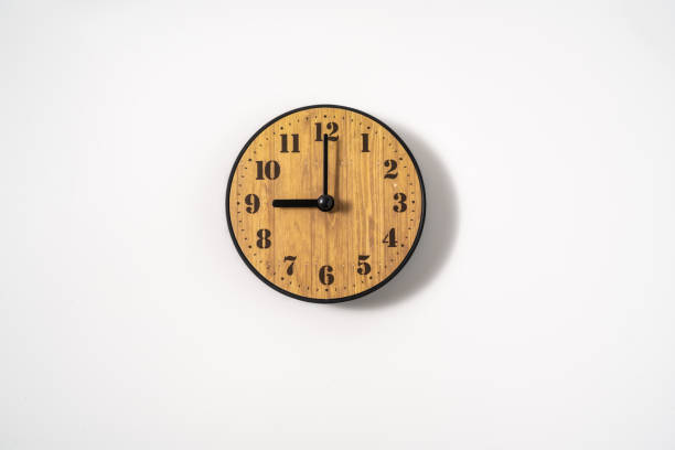 istock wood office wall clock with white dial on white background. wall clock on white background, top view. 1293308572