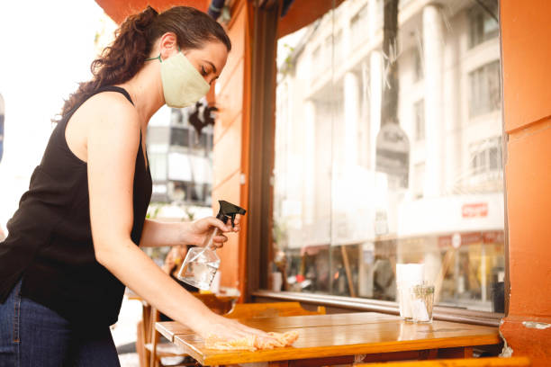 istock employee cleaning the restaurant tables 1293308689