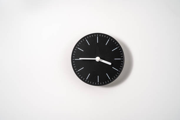 istock close up of an office clock on white background with clipping path 1293308705