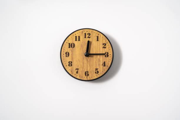 istock wood office wall clock with white dial on white background. wall clock on white background, top view. 1293309857