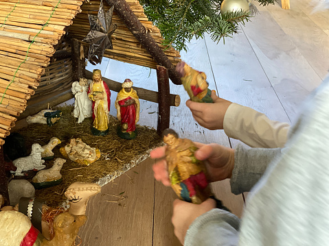 Three wisemen visiting the Nativity with Mary, Joseph.  Selective focus on kneeling wiseman. 