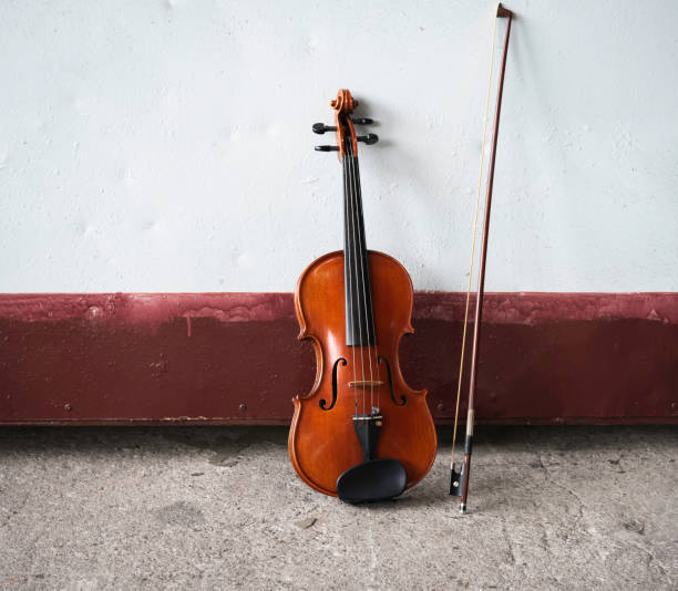 istock Violin and bow put on grunge surface cement ground floor 1293310178