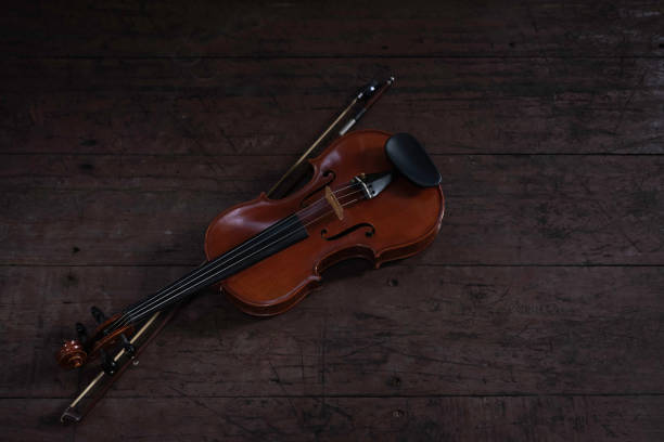istock Violin and bow put on wooden timber board, 1293310180