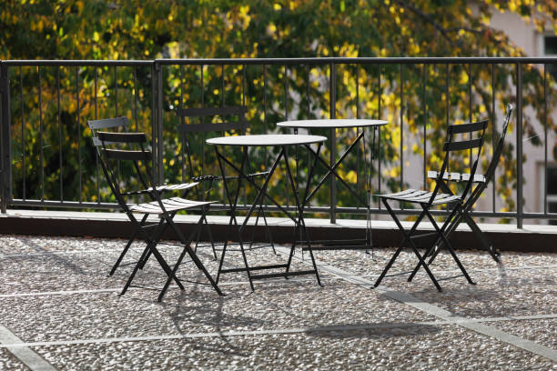 tables and chairs on the balcony on a sunny day