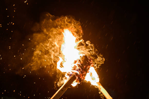two burning torches on a dark background, smoke and fire from burning torches. - flaming torch imagens e fotografias de stock