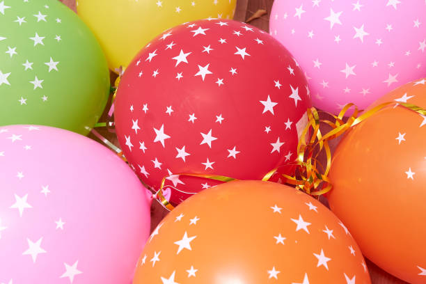 istock Colored balloons with stars forming a bright background wallpaper image. 1293315606