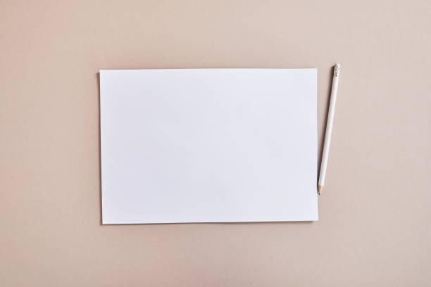 istock top view of blank white paper with pencil on beige surface 1293315913