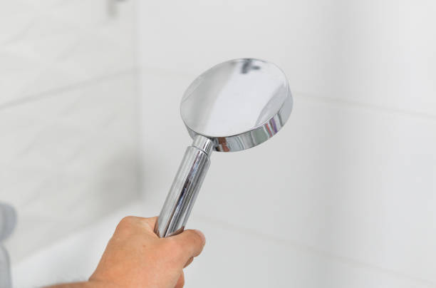 istock Shower heads in a hand inside the shower in a modern bathroom. 1293316636