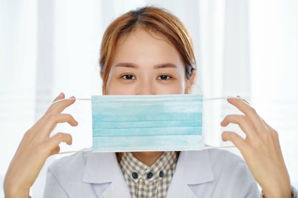 istock Doctor putting on medical mask 1293316685