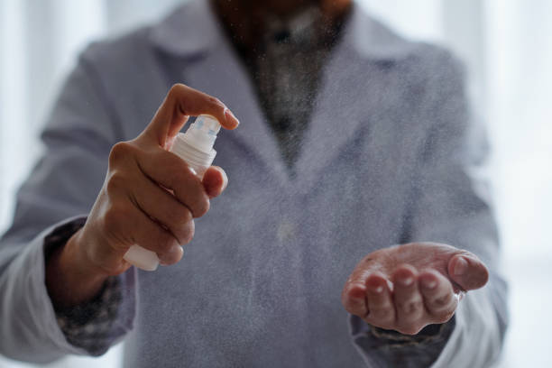 istock Doctor applying anti-bacteria spray 1293316688