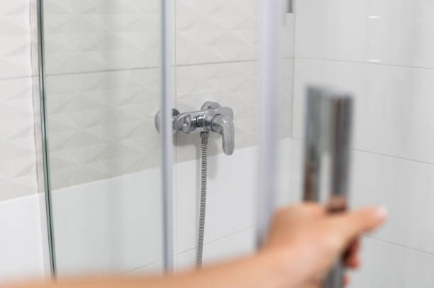 istock Male hand opens the shower door in a modern bathroom. 1293316979