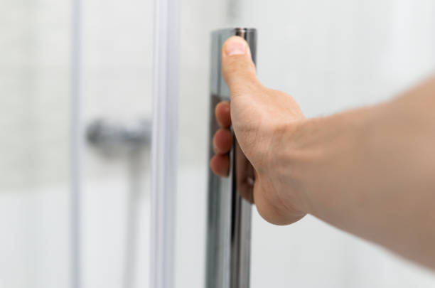 istock Male hand opens the shower door in a modern bathroom. 1293317064