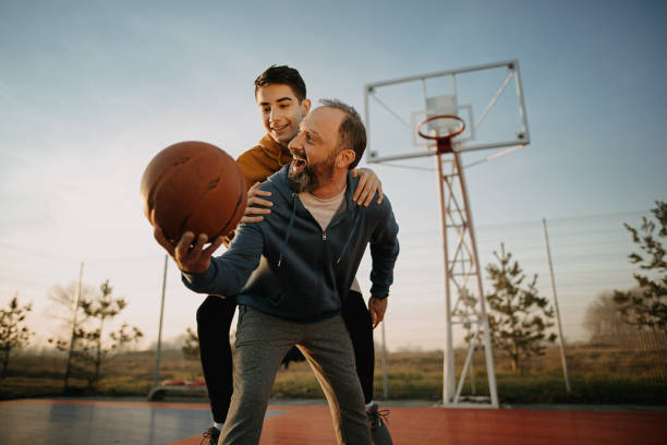 istock Father playing basketball with his son 1293318178