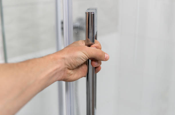 istock Male hand opens the shower door in a modern bathroom. 1293318938