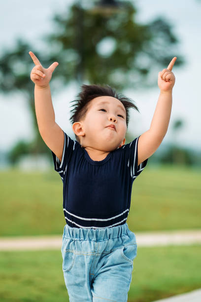 istock Asian chinese cutie boy having fun at public park 1293319368