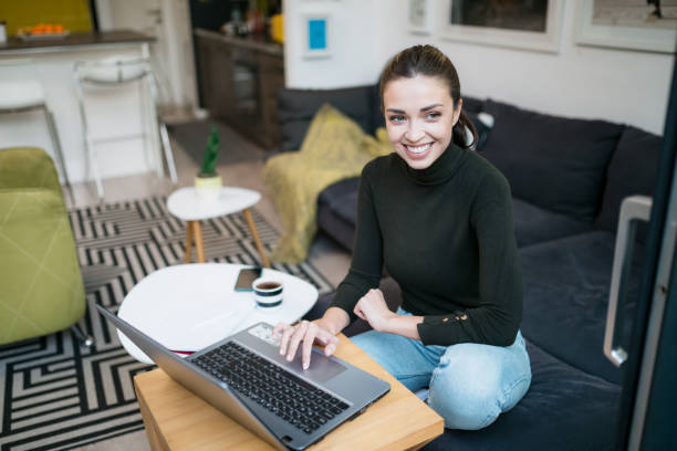istock Beautiful happy Caucasian woman working from home using a laptop 1293320380