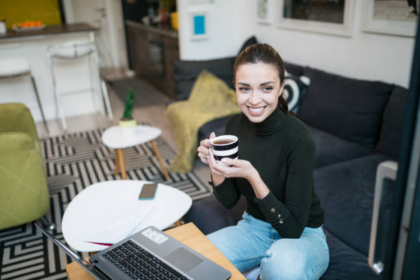 istock Beautiful happy Caucasian woman working from home using a laptop 1293320475