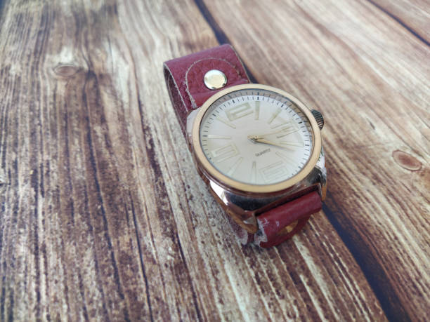 istock Mechanical wrist watch with leather strap on the wooden table background 1293320745