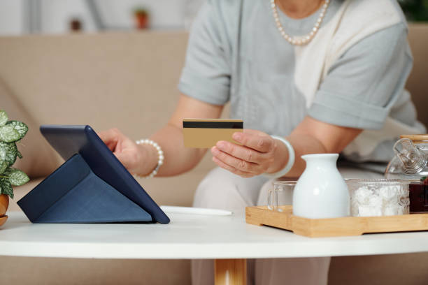 istock Aged woman shopping online 1293320850