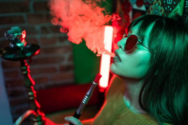 istock Woman smoking narghile 1293322212