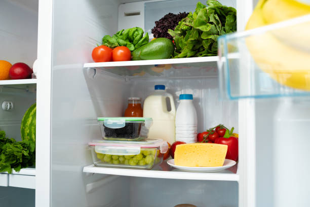 istock Open fridge full of fruits, vegetables and drinks 1293324681